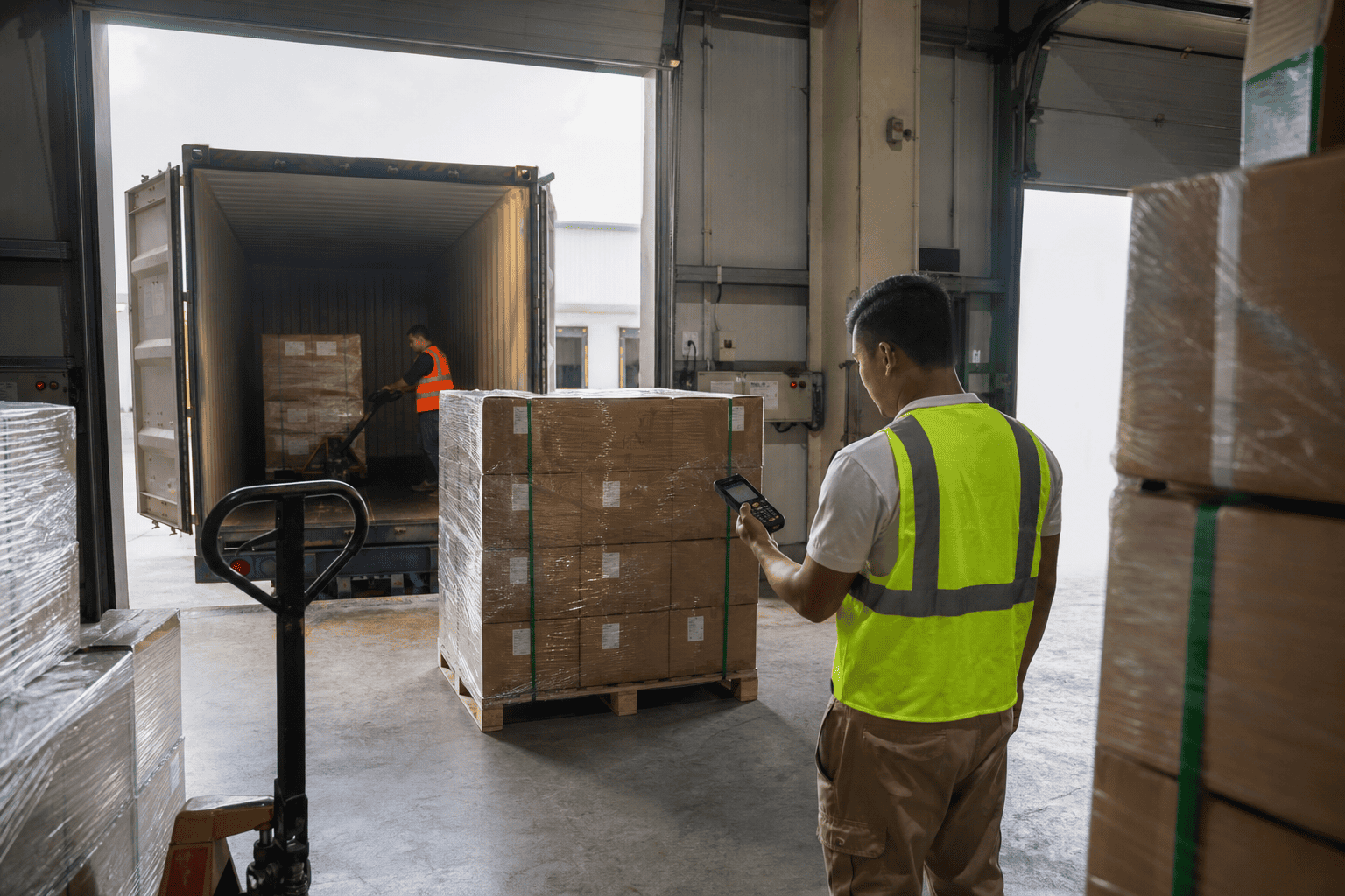 Warehouse manager reviewing inventory and operations in modern logistics facility